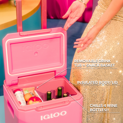 Pink Tag Along Too Igloo cooler with removable drink tub and snack basket, filled with items, on a colorful background.
